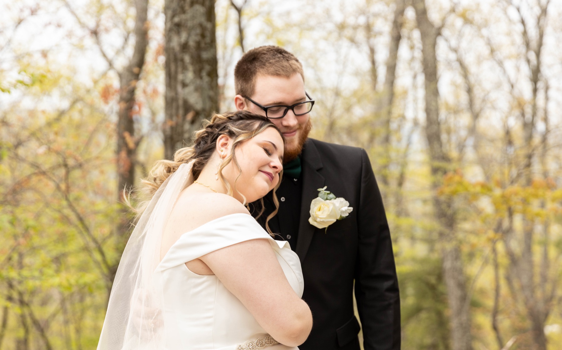 Newlyweds sharing a quiet embrace outdoors